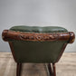 93052 Poltrona a dondolo con struttura in legno e rivestimento in simil pelle verde